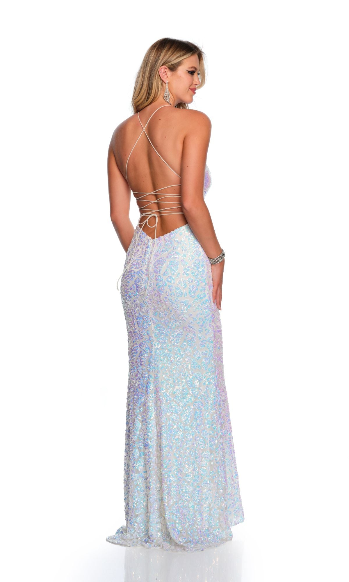 A woman faces away in the Long Formal Dress 11462 by Dave and Johnny—a floor-length, iridescent white sequin prom dress with a low lace-up back and crisscrossed spaghetti straps—set against a plain white background.
